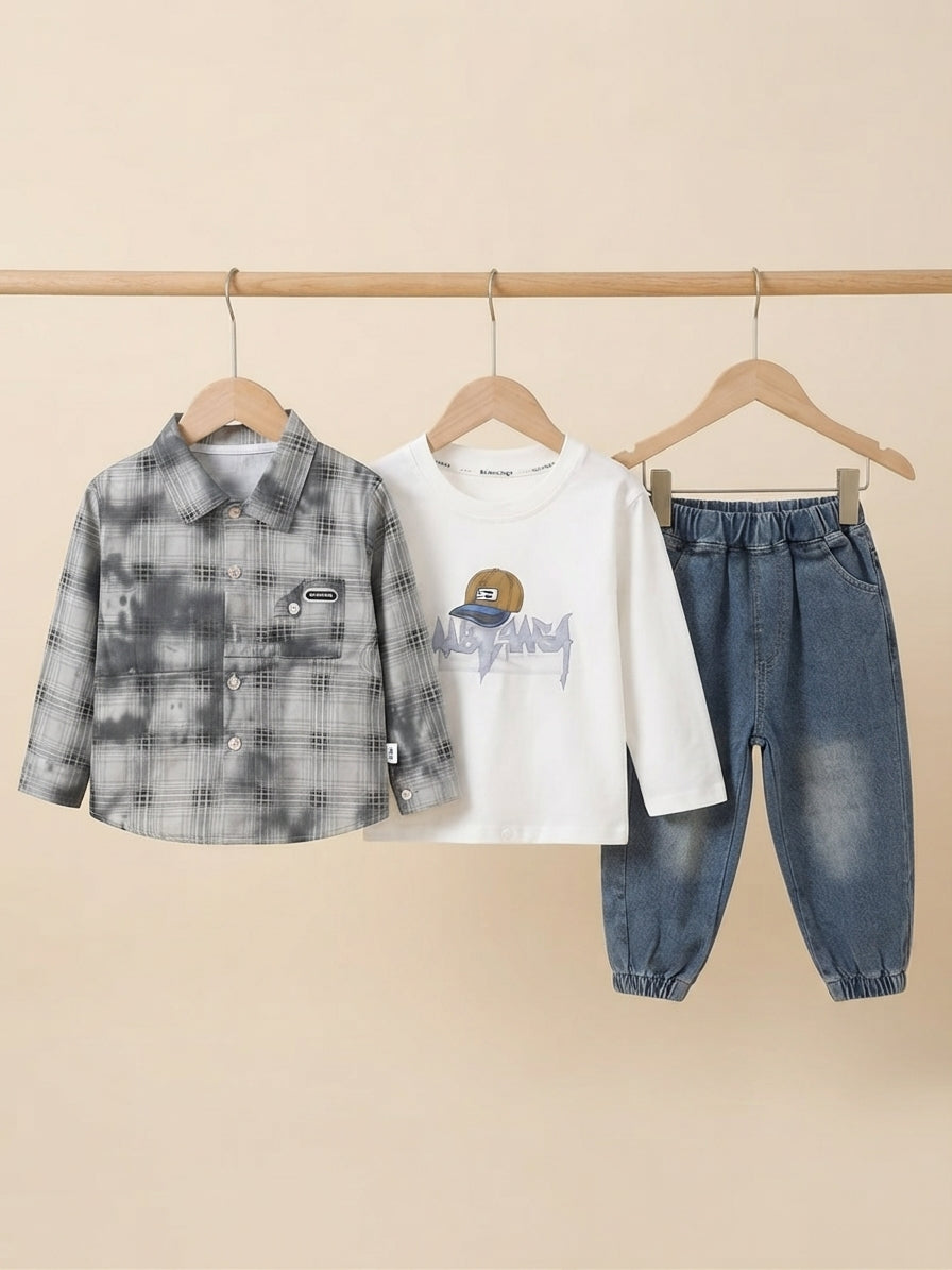 Stylish boys three-piece clothing set featuring a plaid shirt, graphic t-shirt, and denim jeans.